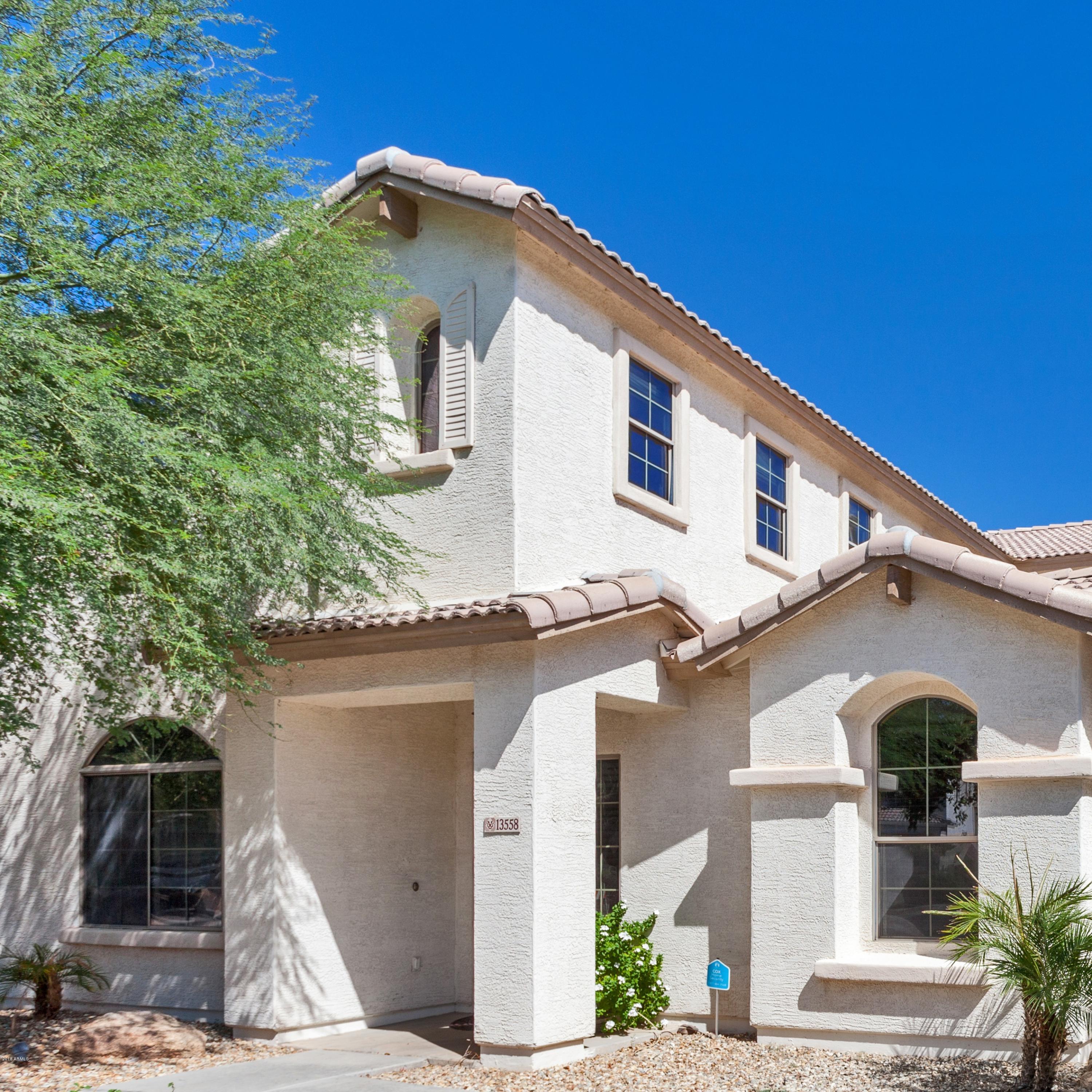 13558 West Calavar Road Surprise, AZ 85379 - Photo 1 of 31 a front view of a house with garage