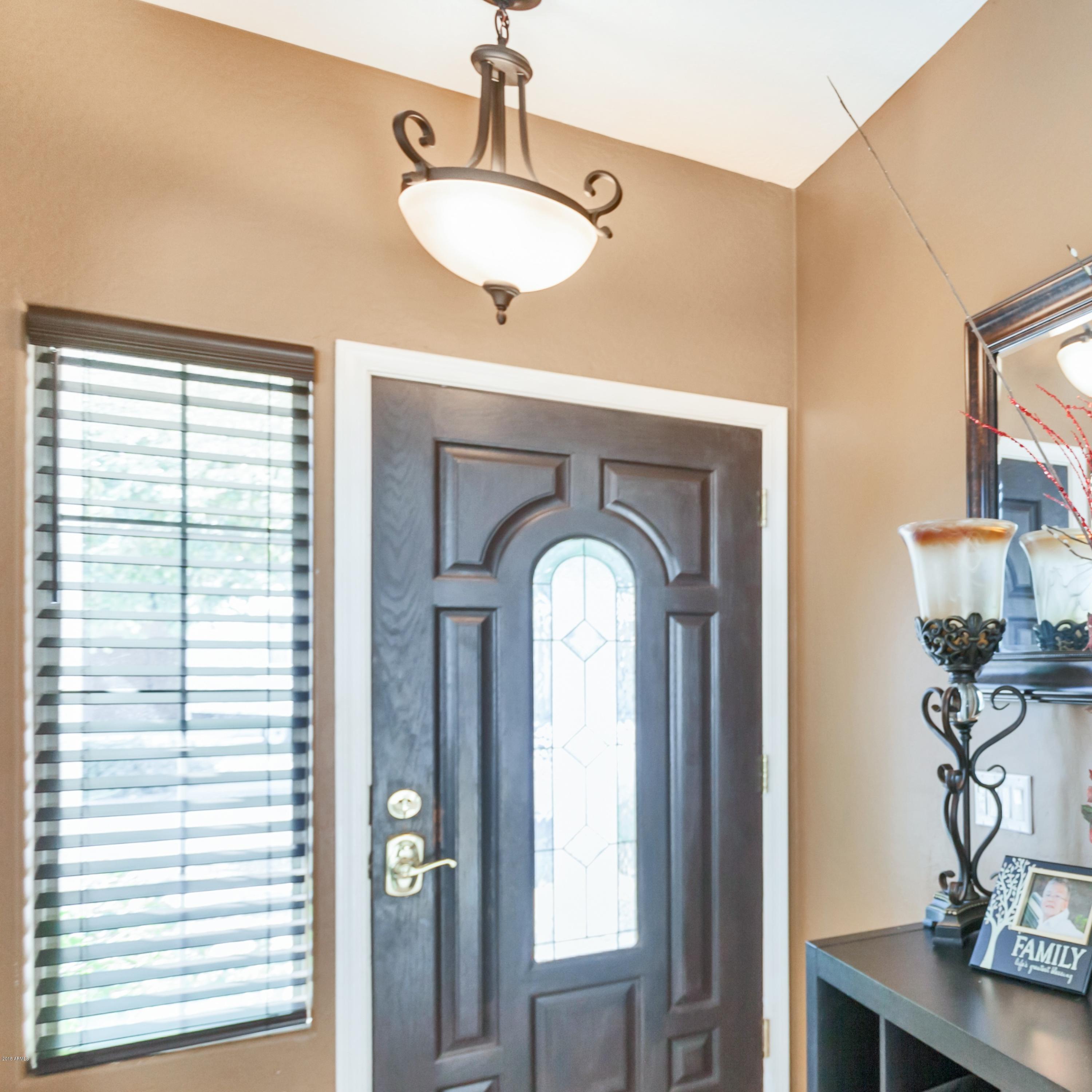 13558 West Calavar Road Surprise, AZ 85379 - Photo 2 of 31 a view of living room with windows and potted plants