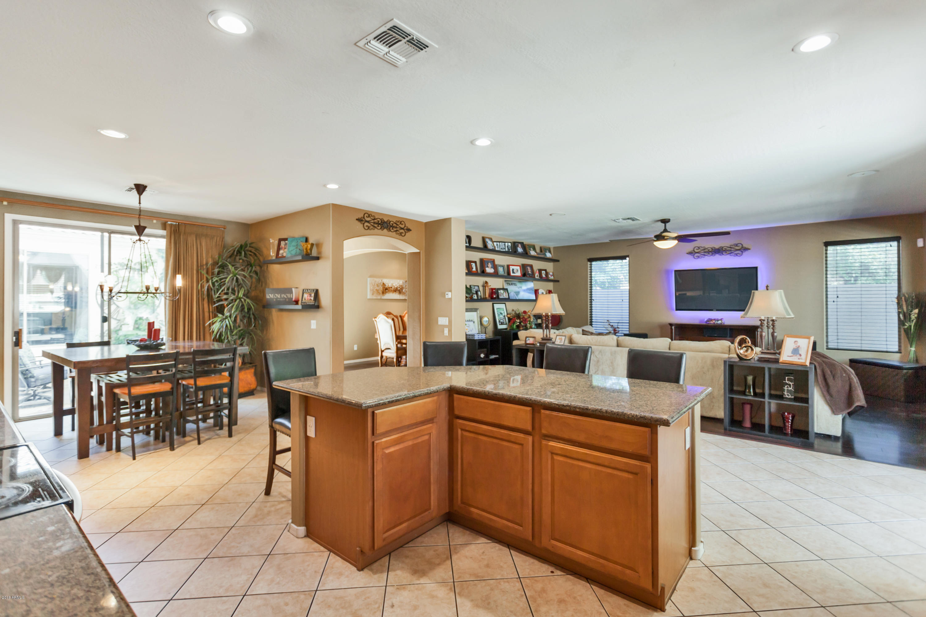 13558 West Calavar Road Surprise, AZ 85379 - Photo 5 of 31 a kitchen with stainless steel appliances granite countertop a sink and cabinets