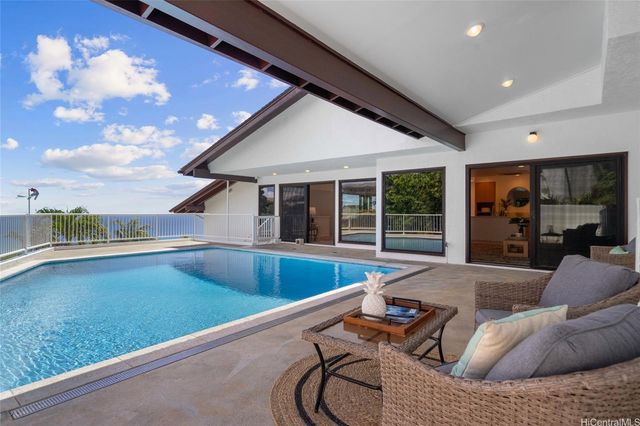 a living room with furniture and floor to ceiling window