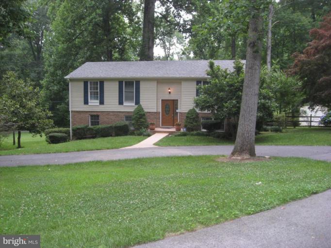 5345 Huntingtown Road Huntingtown, MD 20639 - Photo 1 of 12 a view of a house with a yard and large tree
