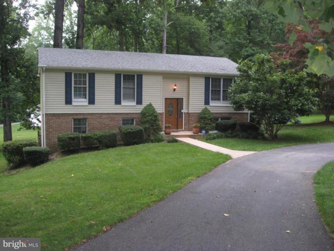 5345 Huntingtown Road Huntingtown, MD 20639 - Photo 2 of 12 a front view of a house with a yard and trees
