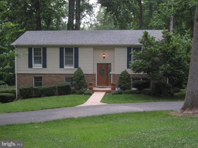 5345 Huntingtown Road Huntingtown, MD 20639 - Photo 5 of 12 a front view of a house with a yard and green space