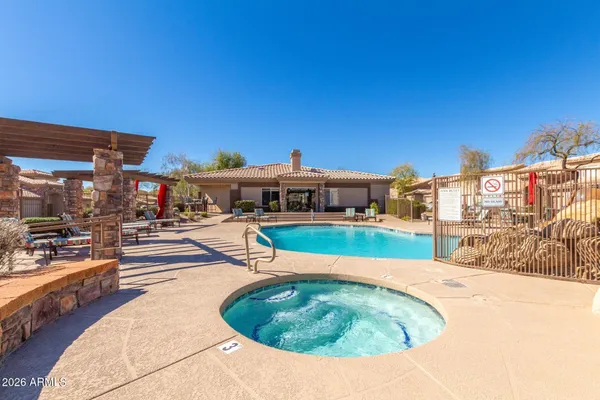 a swimming pool with outdoor seating and yard