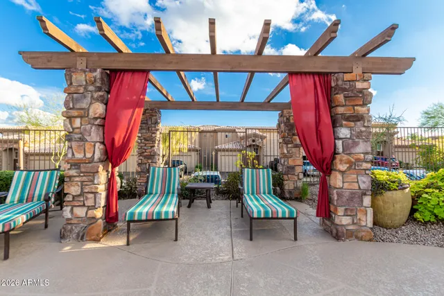 a view of a swimming pool with a patio and a yard