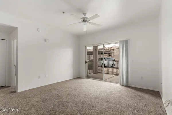 wooden floor in an empty room and a ceiling fan