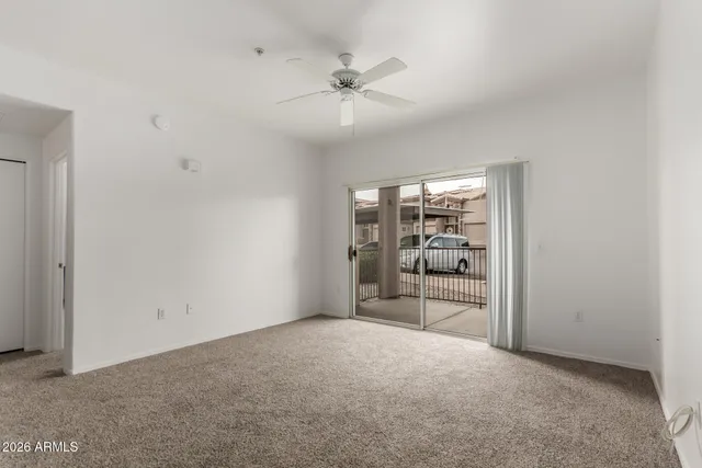 wooden floor in an empty room and a ceiling fan