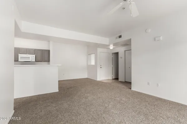 a view of a kitchen with an empty space and a window
