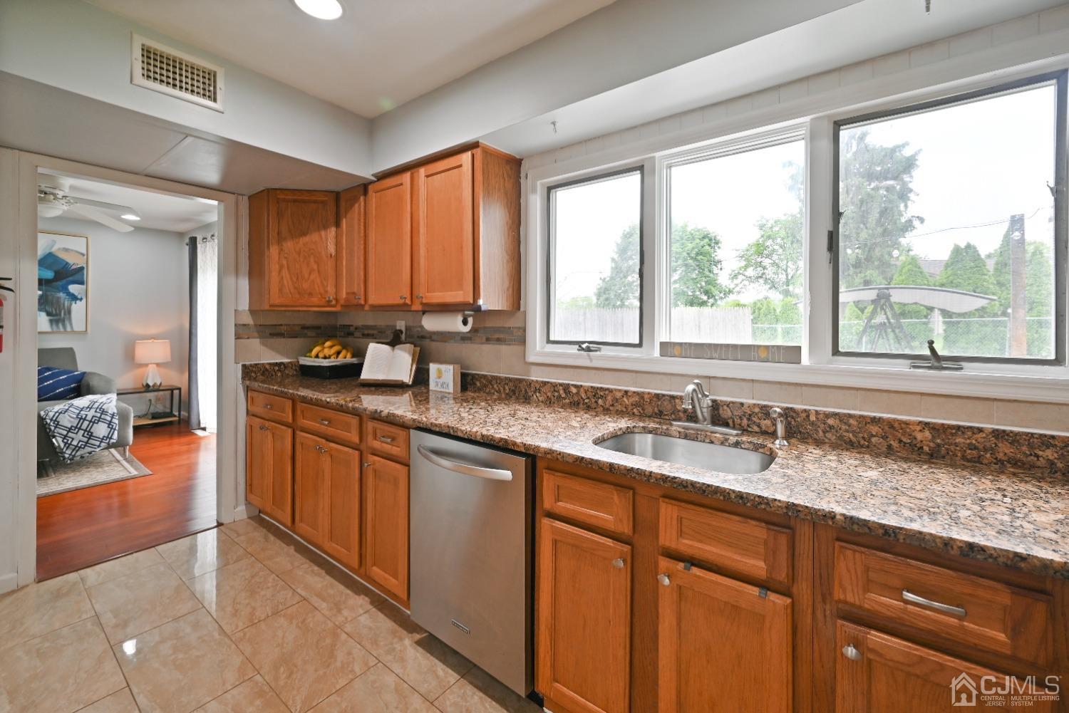 6 Calvin Road Kendall Park, NJ 08824 - Photo 11 of 30 a kitchen with granite countertop a sink and a window