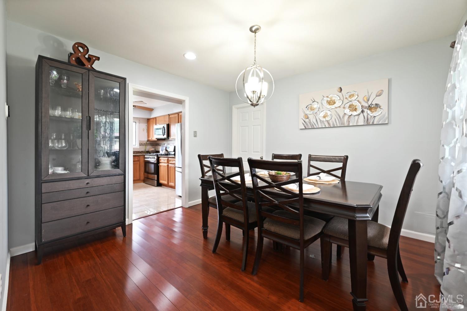 6 Calvin Road Kendall Park, NJ 08824 - Photo 13 of 30 a view of a dining room with furniture and wooden floor