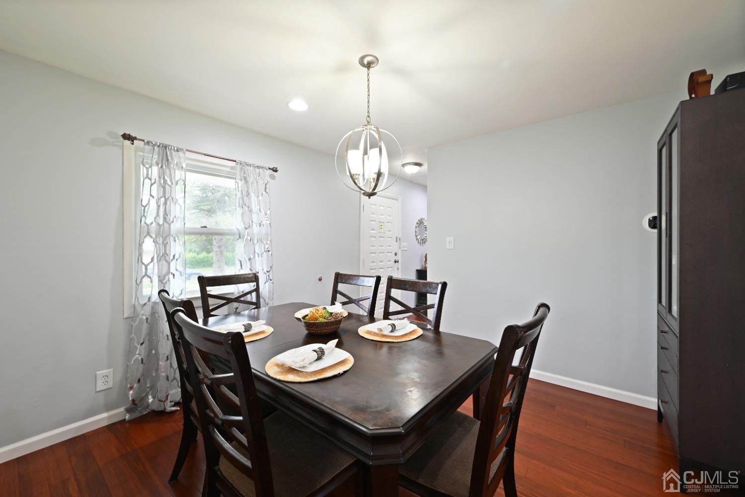 6 Calvin Road Kendall Park, NJ 08824 - Photo 15 of 30 a view of a dining room with furniture window and wooden floor
