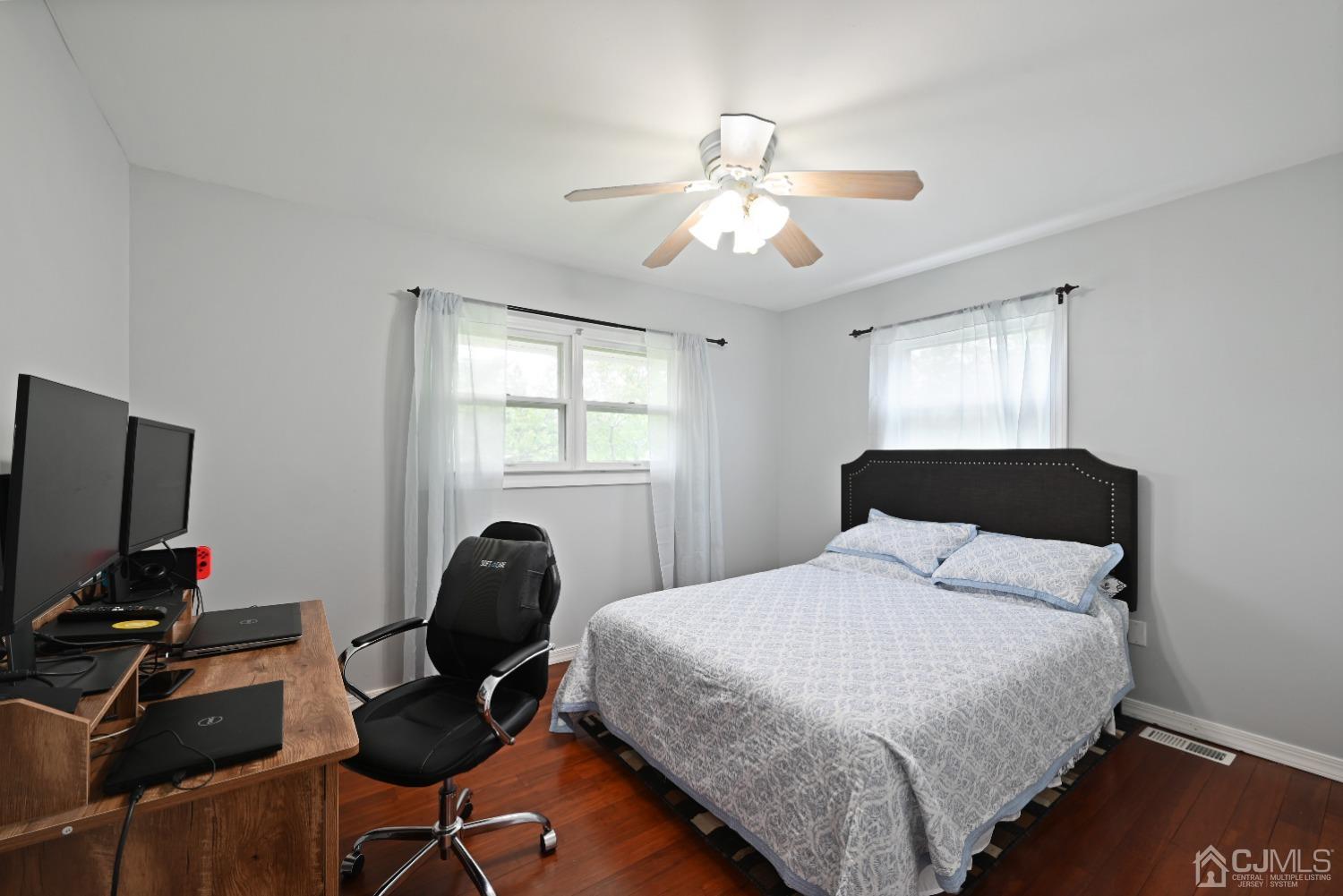 6 Calvin Road Kendall Park, NJ 08824 - Photo 22 of 30 a bedroom with a bed and a flat screen tv