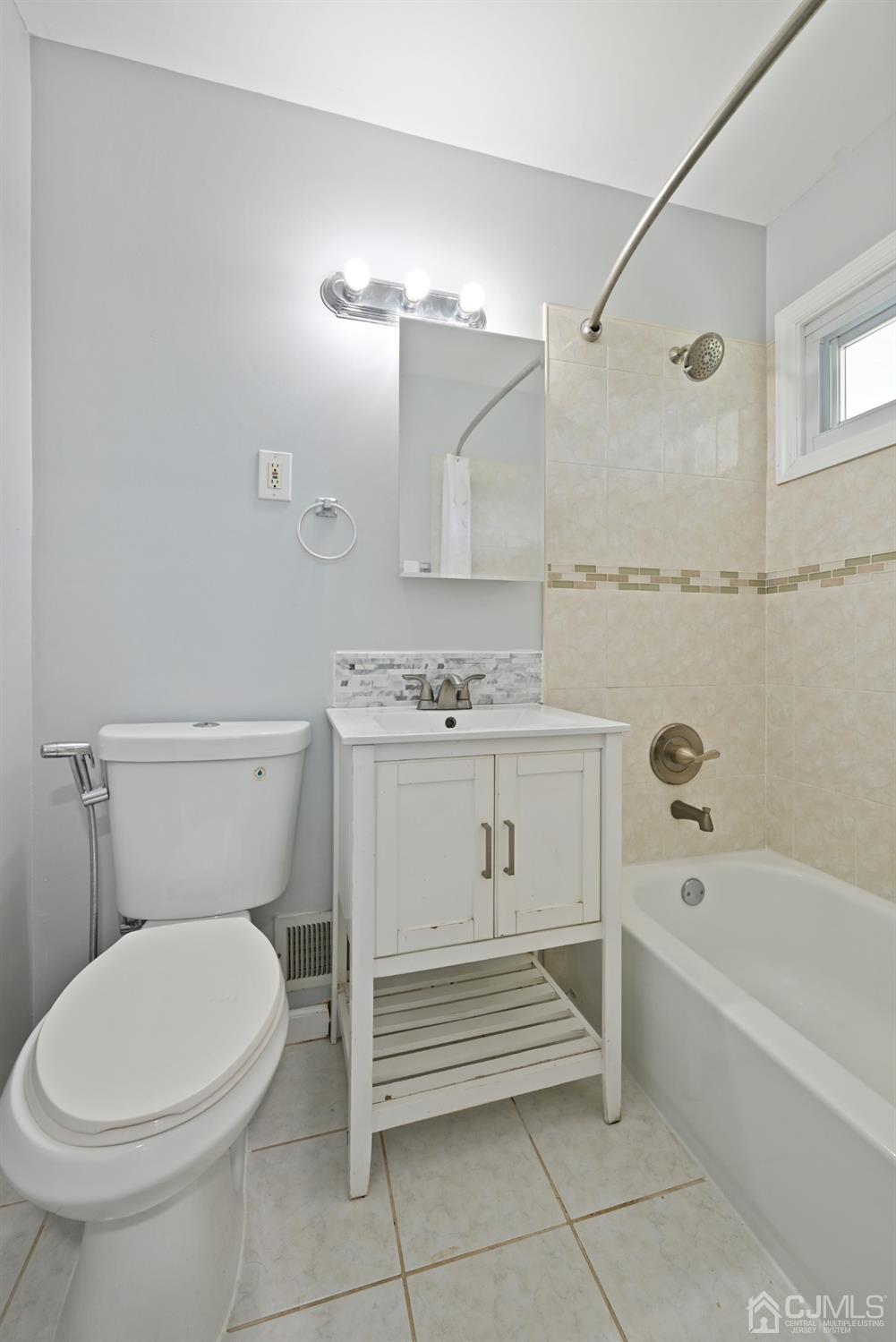 6 Calvin Road Kendall Park, NJ 08824 - Photo 24 of 30 a bathroom with a sink a toilet and bathtub