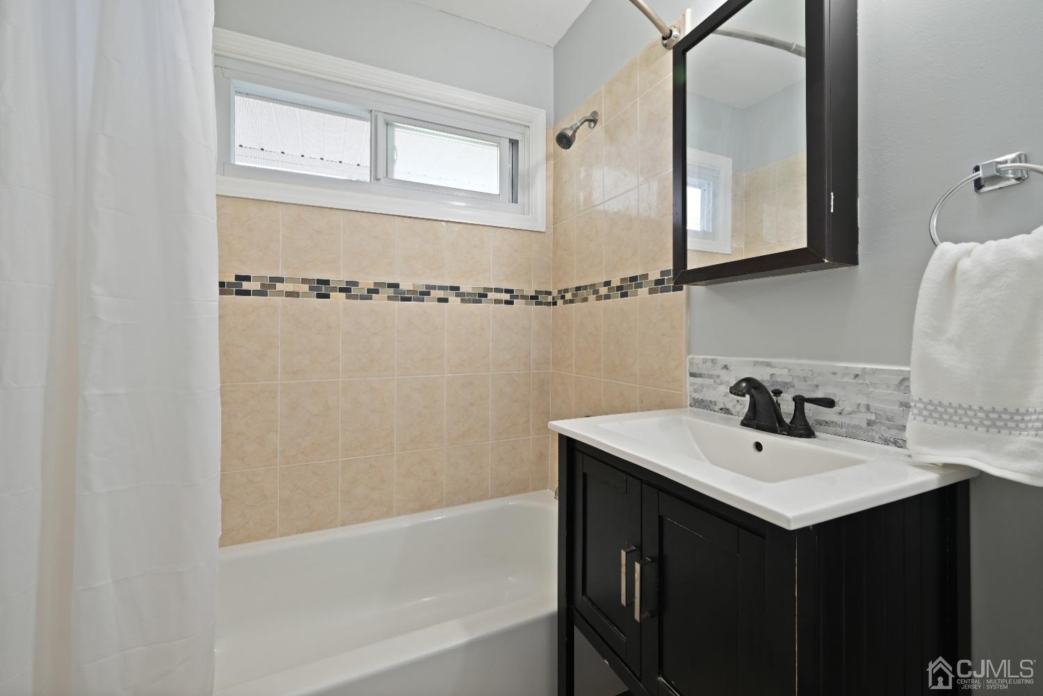 6 Calvin Road Kendall Park, NJ 08824 - Photo 25 of 30 a bathroom with a sink and a mirror