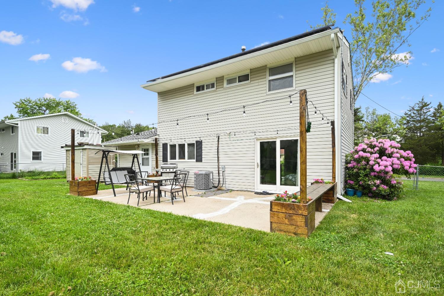 6 Calvin Road Kendall Park, NJ 08824 - Photo 28 of 30 a front view of a house with patio and garden