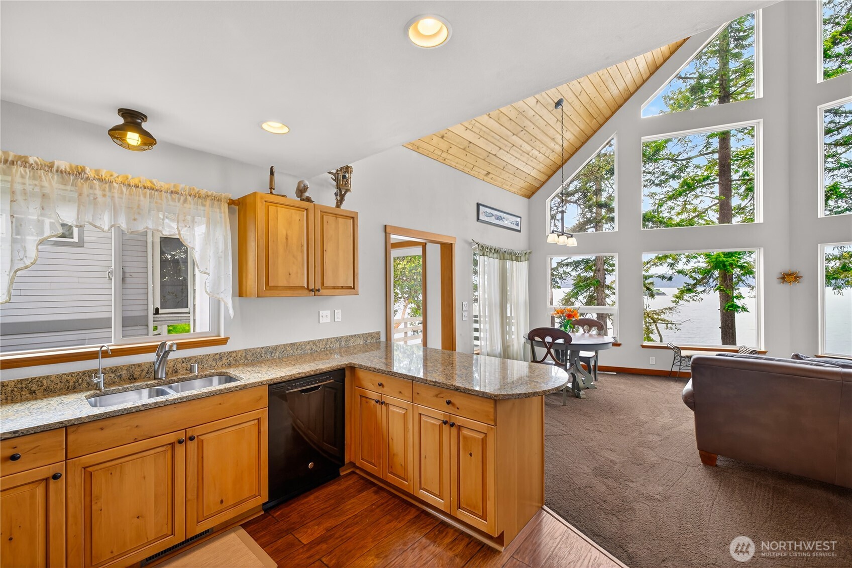 17946 Cobahud Road La Conner, WA 98257 - Photo 26 of 40 a large kitchen with a large window and stainless steel appliances