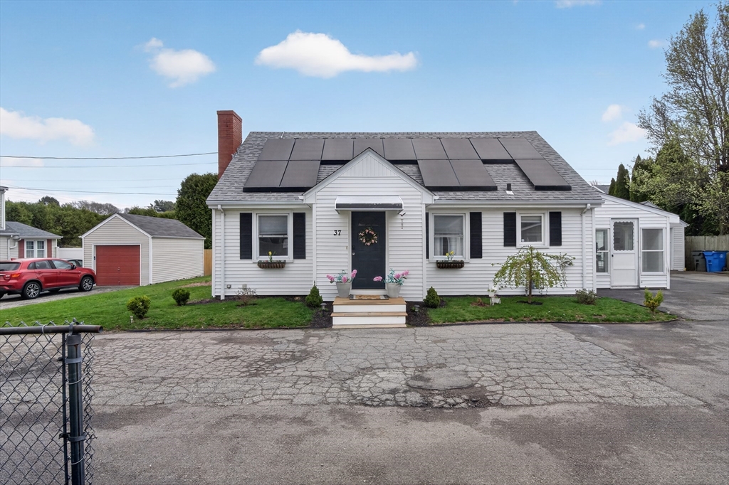 37 Blakely Court Fall River, MA 02720 - Photo 2 of 19 a front view of a house with a yard and garage