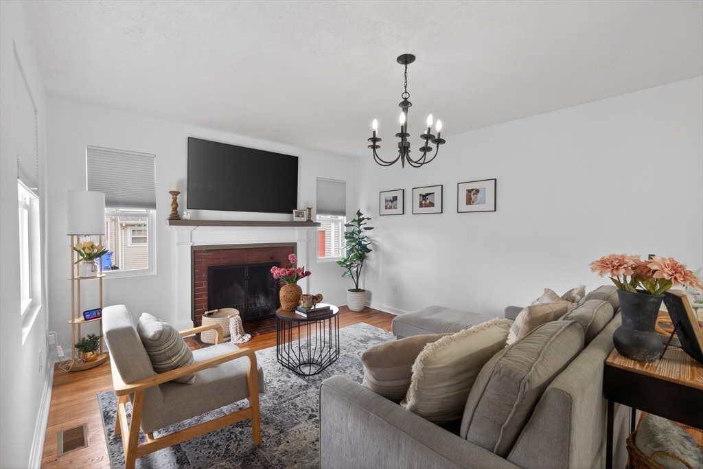 37 Blakely Court Fall River, MA 02720 - Photo 10 of 19 a living room with furniture a fireplace and a flat screen tv