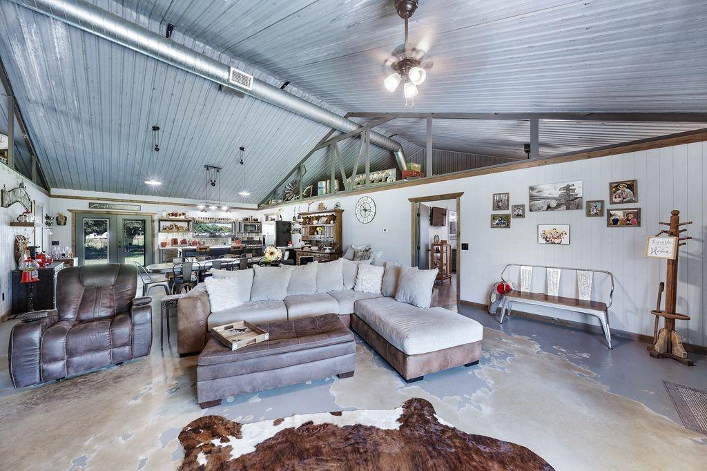 50 County Road Blossom, TX 75416 - Photo 13 of 40 a living room with furniture and a chandelier