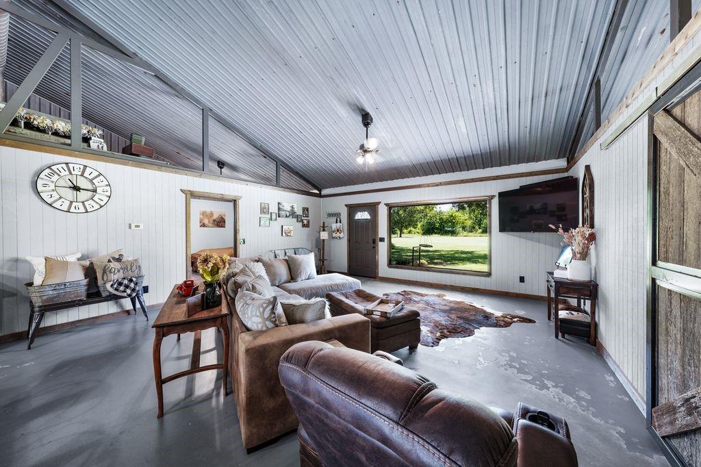 50 County Road Blossom, TX 75416 - Photo 14 of 40 a living room with furniture a large window and a flat screen tv