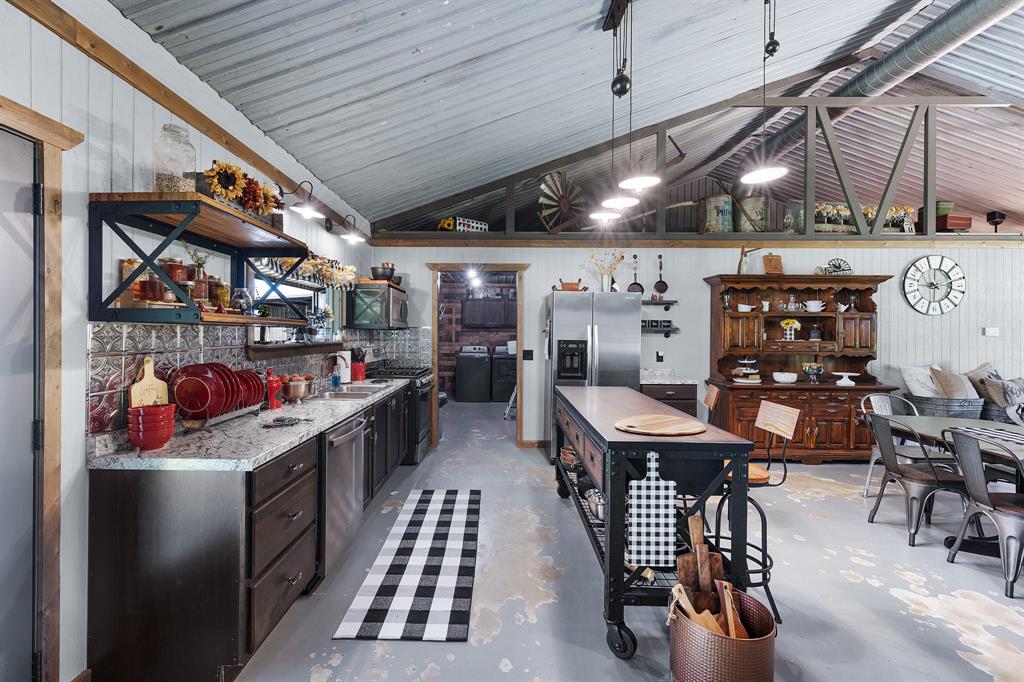 50 County Road Blossom, TX 75416 - Photo 19 of 40 a kitchen with stainless steel appliances kitchen island granite countertop lots of counter top space