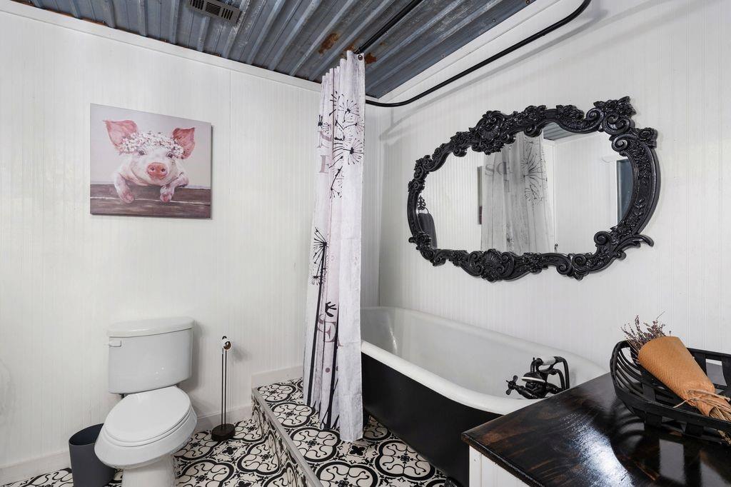 50 County Road Blossom, TX 75416 - Photo 28 of 40 a bathroom with a toilet and a mirror