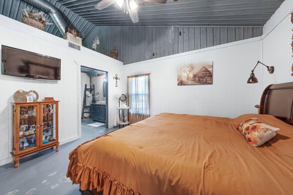 50 County Road Blossom, TX 75416 - Photo 30 of 40 a bedroom with a bed and a flat screen tv