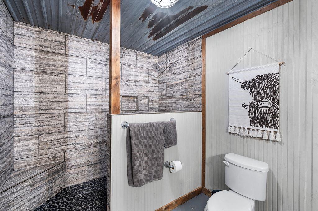 50 County Road Blossom, TX 75416 - Photo 32 of 40 a bathroom with a toilet and a shower