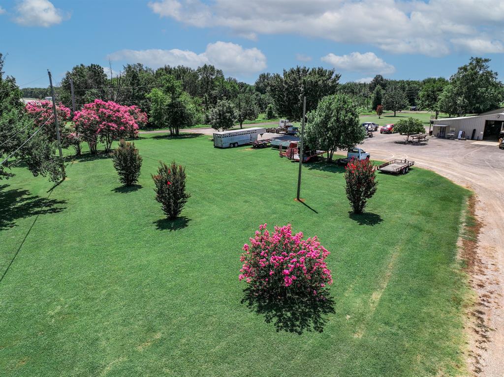 50 County Road Blossom, TX 75416 - Photo 4 of 40 a view of a garden with flowers and trees