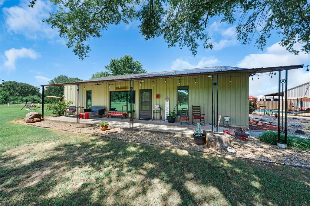50 County Road Blossom, TX 75416 - Photo 6 of 40 a view of a porch with a table and chairs under an umbrella