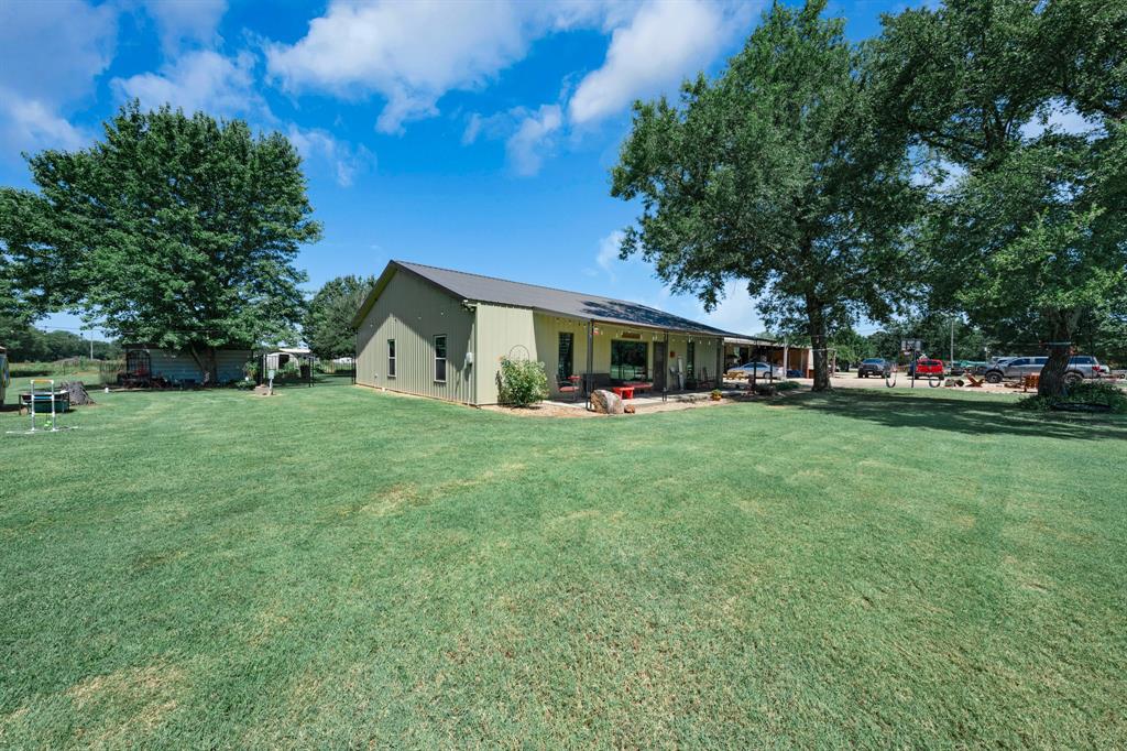 50 County Road Blossom, TX 75416 - Photo 7 of 40 a view of a house with a big yard and sitting area