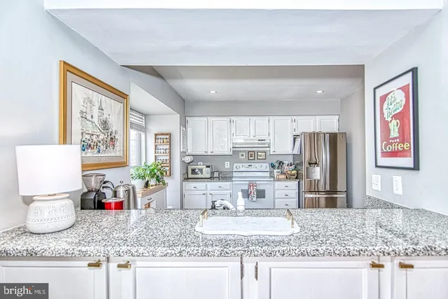 a bathroom with a granite countertop sink a vanity and shower