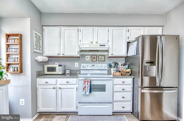 a view of a workspace with furniture and a chandelier
