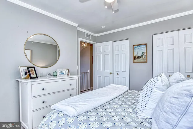 a bedroom with a bed a chandelier and closet