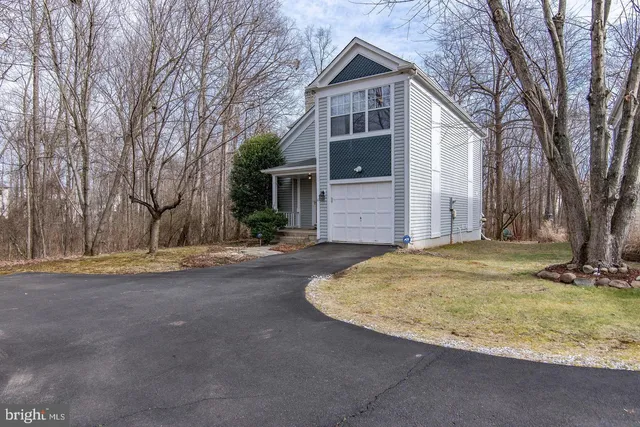 a view of a house with a yard covered with snow