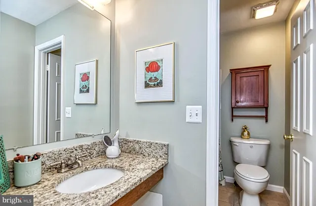 a bedroom with a bed flat screen tv and a chandelier