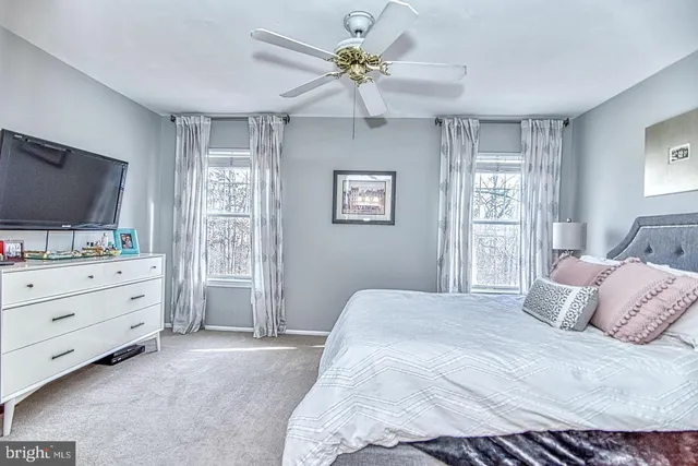 a view of an empty room with stairs and a window