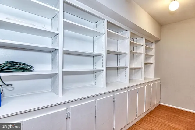 a view of a house with a wooden deck and a yard with stairs