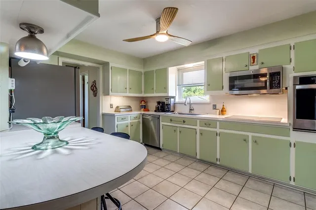 a kitchen with a table and chairs in it