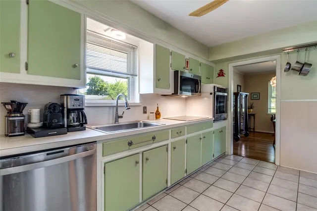 a kitchen with a sink window and cabinets