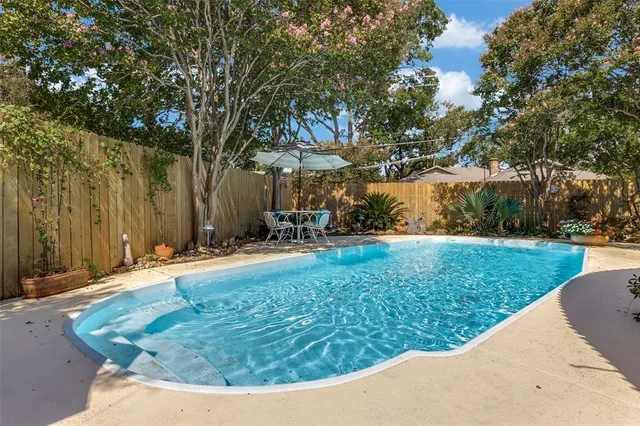 a view of a backyard with large trees
