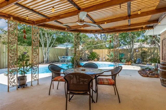 a view of patio with a table and chairs under an umbrella