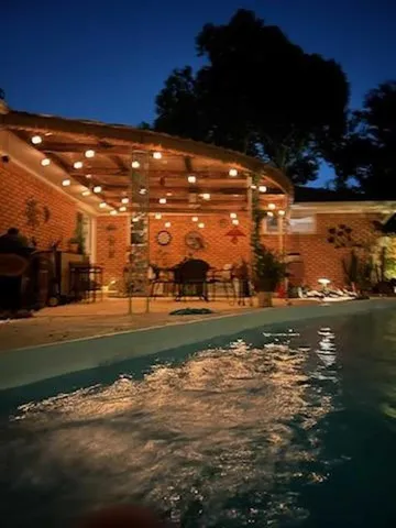 a view of a fountain in front of the house