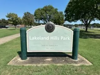 a view of a park with large trees