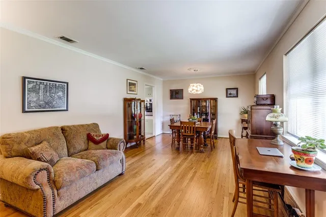 a living room with furniture dining table and a flat screen tv