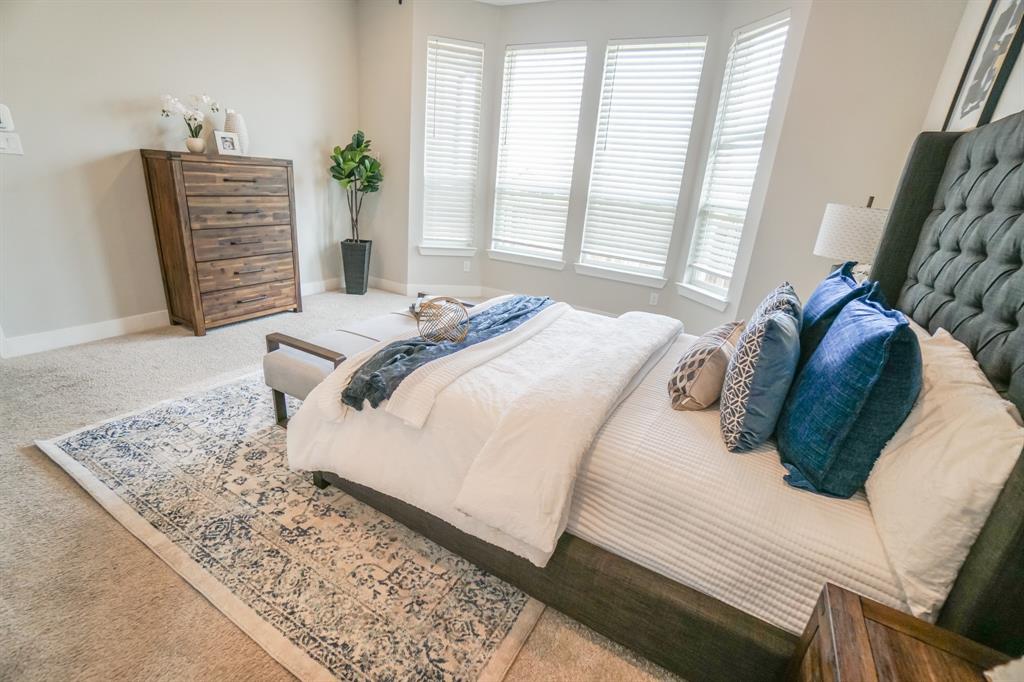 1309 Old Rocksprings Pass Mansfield, TX 76063 - Photo 11 of 36 Expansive bedroom featuring wall-to-wall carpeting and a bay window with horizontal blinds