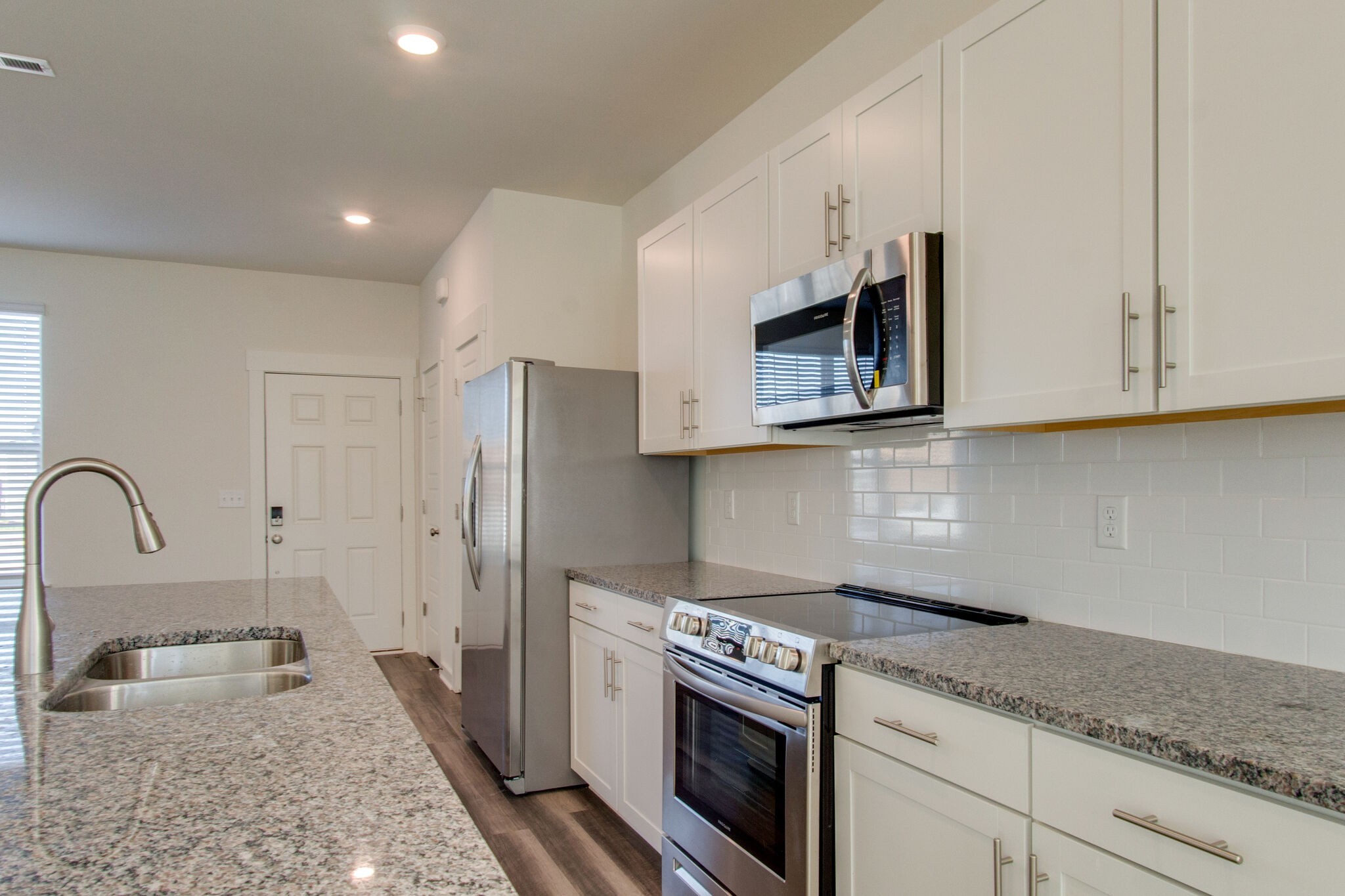 1703 Frodo Way Murfreesboro, TN 37128 - Photo 6 of 25 a kitchen with stainless steel appliances granite countertop a stove a sink and a refrigerator