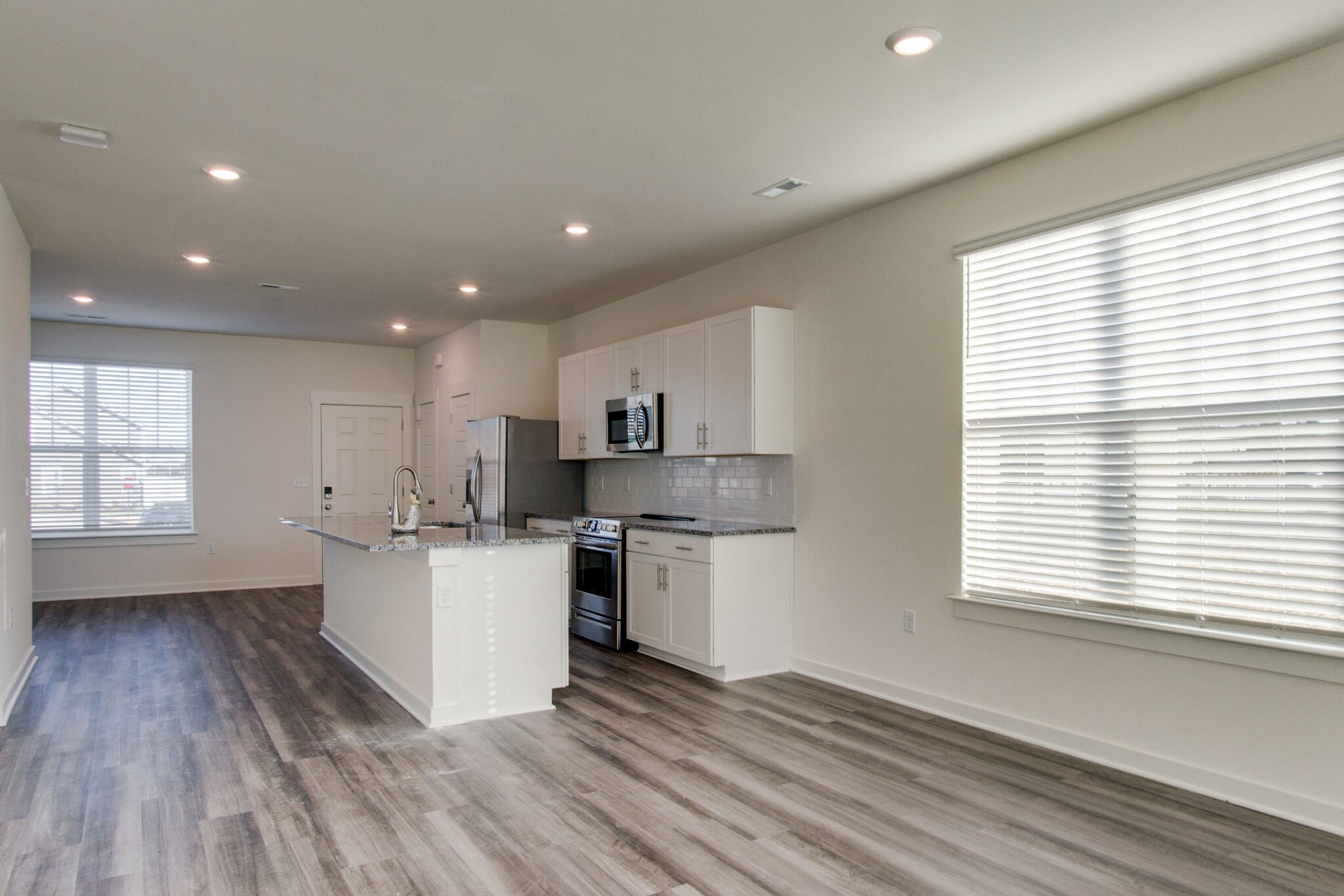 1703 Frodo Way Murfreesboro, TN 37128 - Photo 10 of 25 a kitchen with a wooden floor and white appliances