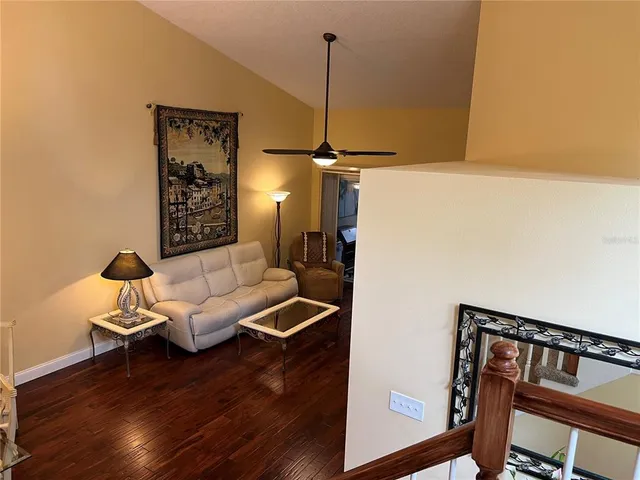 a kitchen with stainless steel appliances granite countertop a stove top oven a sink dishwasher and wooden cabinets with wooden floor