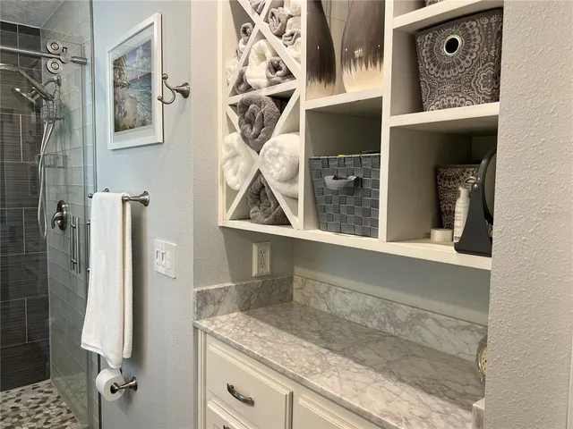 a view of staircase with railing and a window